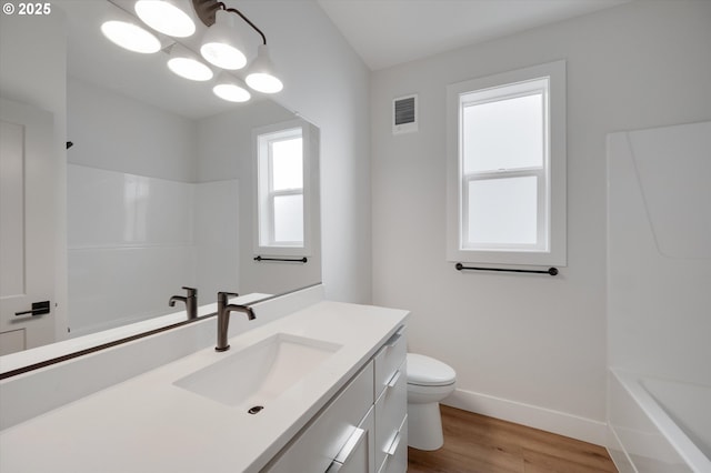 bathroom featuring vanity, a notable chandelier, wood-type flooring, and toilet