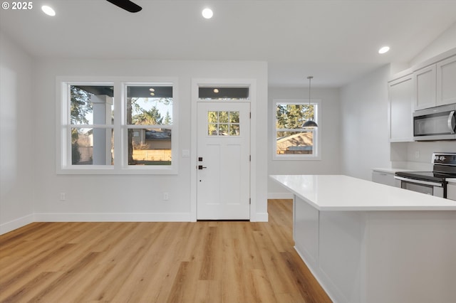 entryway featuring ceiling fan and light wood-type flooring