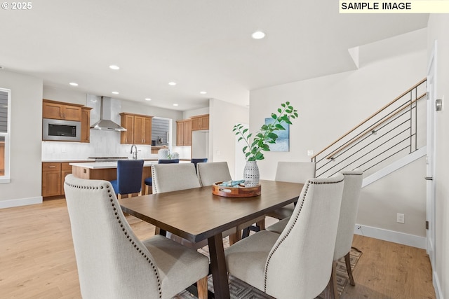8276 SE Orion Ln, Hillsboro, OR 97123 - dining space featuring light wood finished floors, recessed lighting, baseboards, and stairway