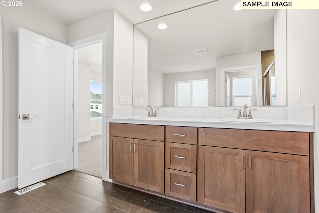 8276 SE Orion Ln, Hillsboro, OR 97123 - bathroom featuring plenty of natural light, double vanity, recessed lighting, and baseboards