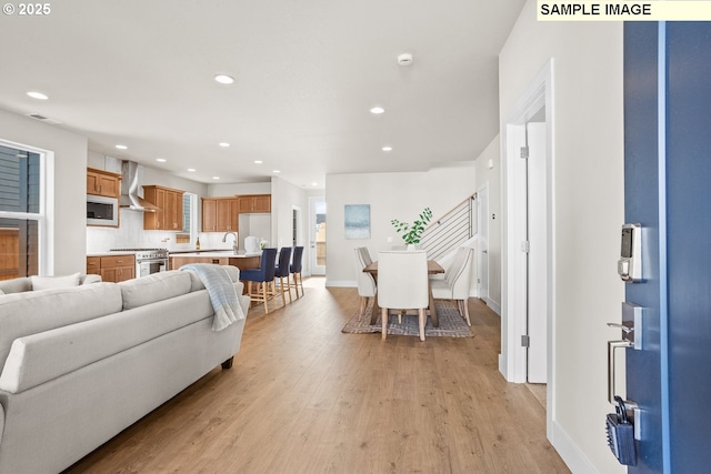 8276 SE Orion Ln, Hillsboro, OR 97123 - living area featuring light wood-type flooring, recessed lighting, and baseboards