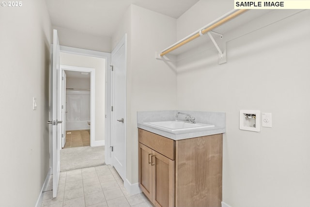 8276 SE Orion Ln, Hillsboro, OR 97123 - laundry room featuring hookup for a washing machine, baseboards, light colored carpet, and light tile patterned floors