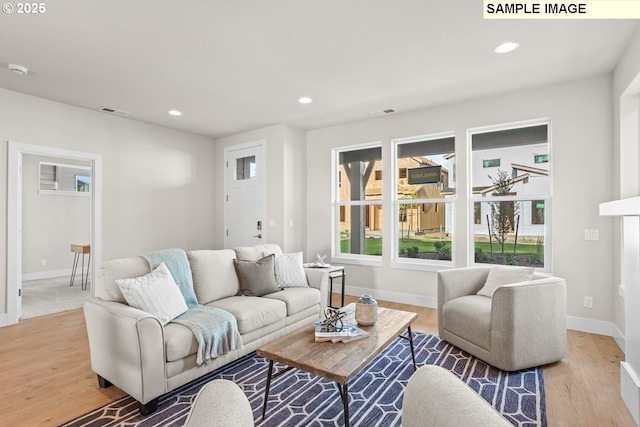 8276 SE Orion Ln, Hillsboro, OR 97123 - living room with light wood-style flooring, baseboards, and recessed lighting