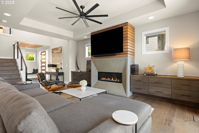 4480 Upper Dr, Lake Oswego, OR 97035 - living area with a tray ceiling, wood finished floors, recessed lighting, ceiling fan, and stairway
