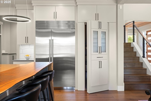 4480 Upper Dr, Lake Oswego, OR 97035 - kitchen featuring built in refrigerator, dark wood finished floors, and white cabinetry