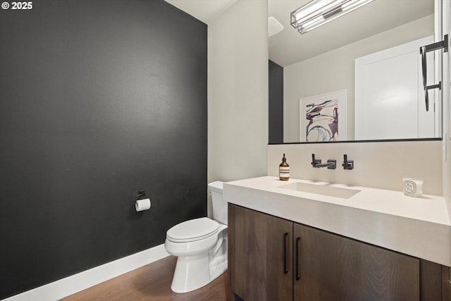 4480 Upper Dr, Lake Oswego, OR 97035 - bathroom with vanity, toilet, baseboards, wood finished floors, and vaulted ceiling