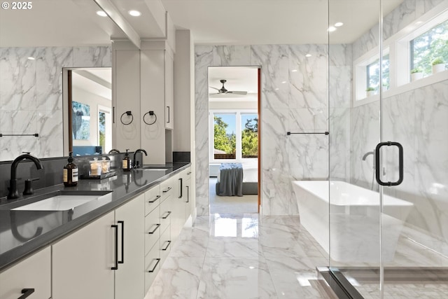 4480 Upper Dr, Lake Oswego, OR 97035 - bathroom featuring marble tiled floors, ensuite bathroom, double vanity, a freestanding bath, and tile walls