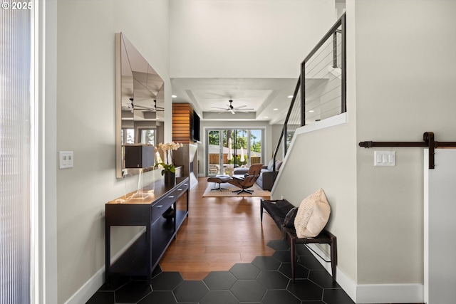 4480 Upper Dr, Lake Oswego, OR 97035 - hallway with a tray ceiling, dark wood-type flooring, and a barn door