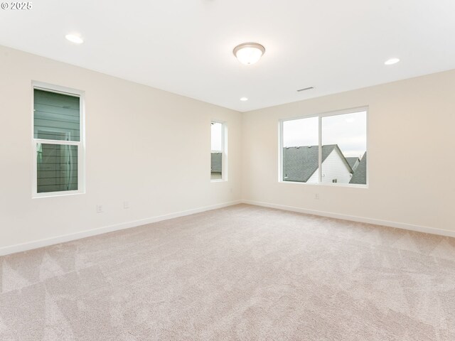 unfurnished room featuring light carpet, baseboards, and recessed lighting