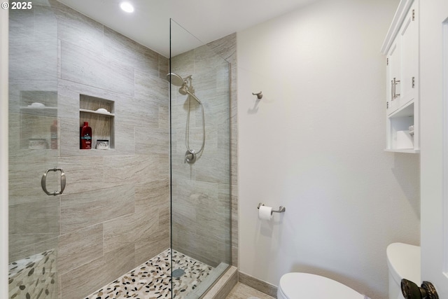 bathroom with recessed lighting, a stall shower, and toilet