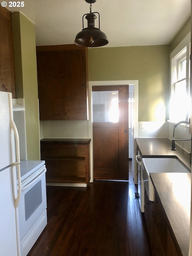 3929 SE 65th Ave, Portland, OR 97206 - kitchen featuring white appliances, dark wood-type flooring, and hanging light fixtures