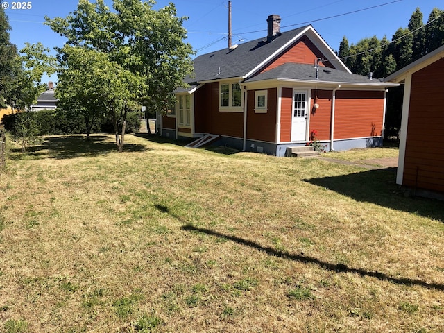 3929 SE 65th Ave, Portland, OR 97206 - rear view of property with entry steps, a yard, and a shingled roof