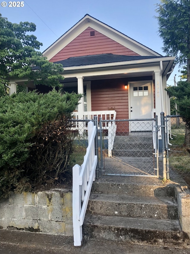 3929 SE 65th Ave, Portland, OR 97206 - shotgun-style home with a porch, a fenced front yard, and a gate