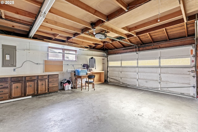 garage with electric panel and a garage door opener