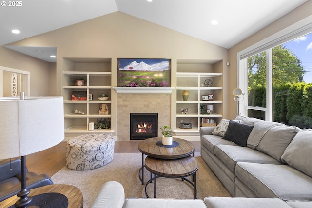 14206 SE Woodside Ave, Milwaukie, OR 97267 - living room featuring built in features, wood finished floors, lofted ceiling, a tiled fireplace, and recessed lighting