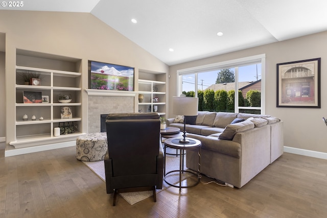 14206 SE Woodside Ave, Milwaukie, OR 97267 - living room with built in shelves, lofted ceiling, wood finished floors, baseboards, and a fireplace