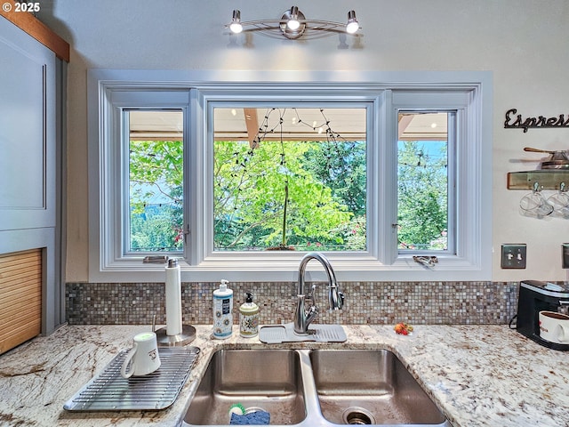 10059 SW 57th Pl, Portland, OR 97219 - kitchen featuring backsplash, light stone counters, and a sink