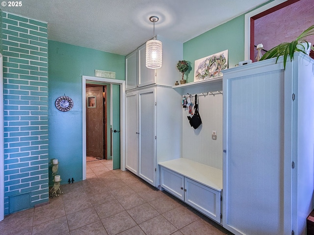 10059 SW 57th Pl, Portland, OR 97219 - mudroom with tile patterned floors and a textured ceiling