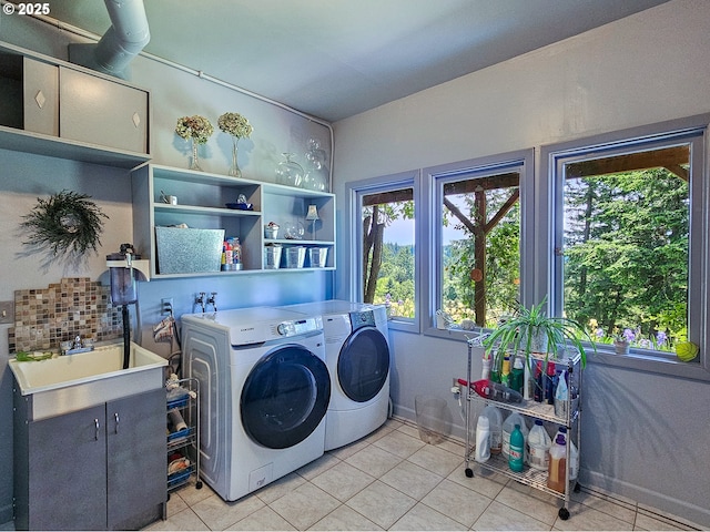 10059 SW 57th Pl, Portland, OR 97219 - laundry room with separate washer and dryer, cabinet space, light tile patterned floors, and baseboards