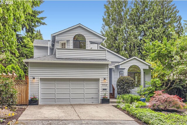 7710 SW Ruby Ter, Portland, OR 97219 - view of front facade with driveway, roof with shingles, and an attached garage