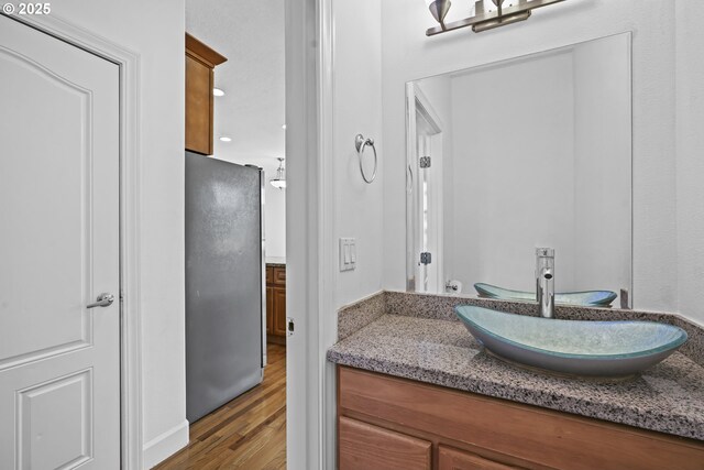 bathroom with vanity and wood-type flooring