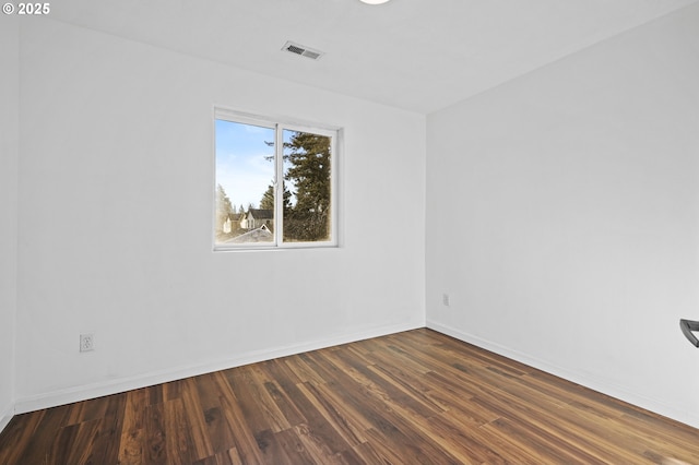 unfurnished room featuring dark wood-type flooring