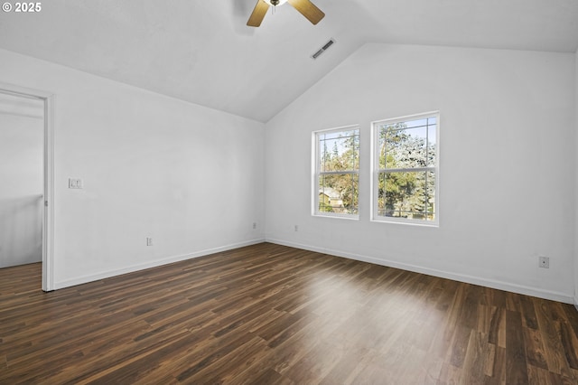 empty room featuring ceiling fan, dark wood-type flooring, and vaulted ceiling