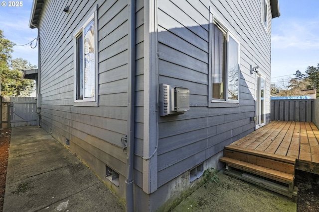 view of side of home with a wall mounted air conditioner