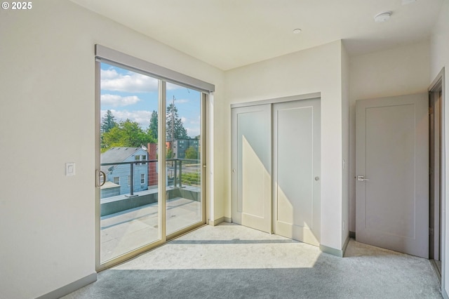 entryway with light colored carpet