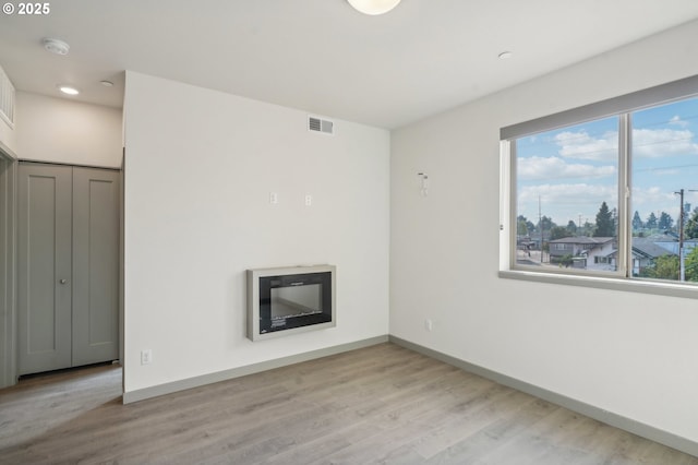 spare room with light hardwood / wood-style flooring