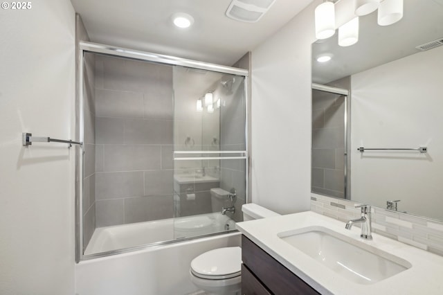 full bathroom featuring toilet, enclosed tub / shower combo, backsplash, and vanity