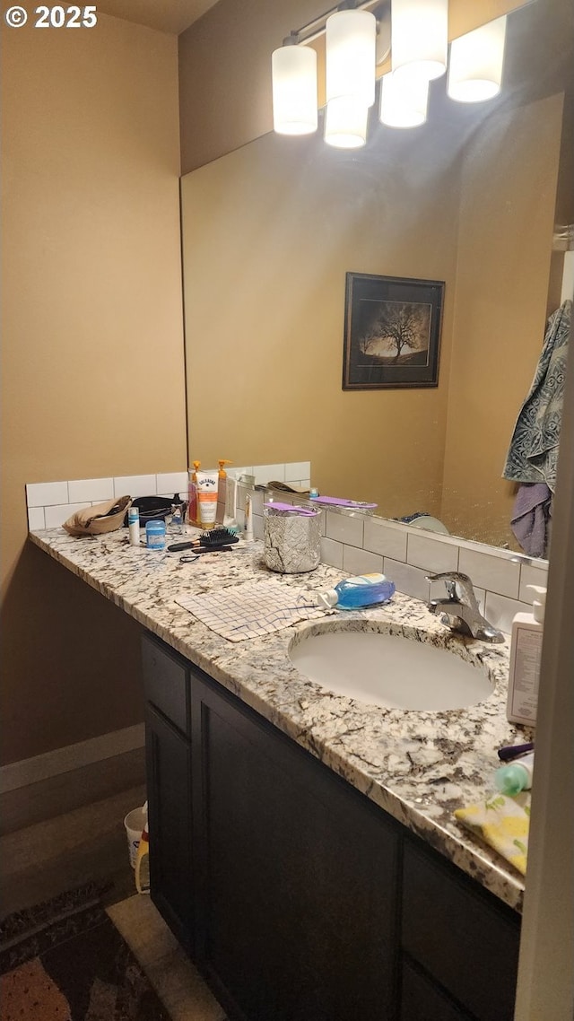 bathroom featuring vanity and a notable chandelier