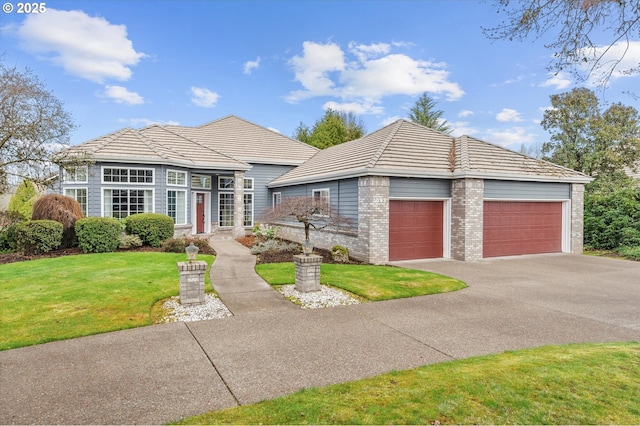 view of front of home featuring brick siding, a front lawn, and a tiled roof