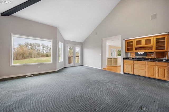 unfurnished living room with light colored carpet, french doors, visible vents, and baseboards