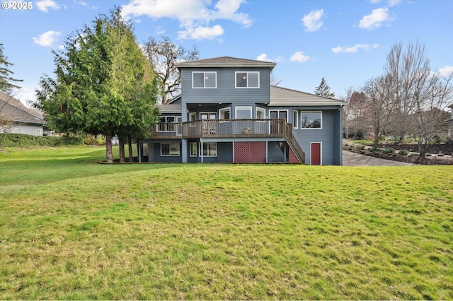 rear view of property featuring a yard, a deck, and stairway