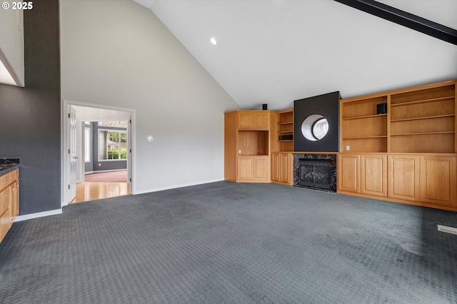 unfurnished living room with high vaulted ceiling, recessed lighting, a fireplace, dark colored carpet, and baseboards