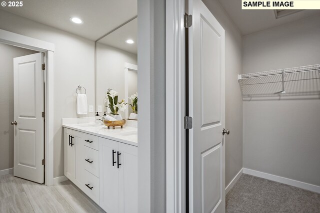 17407 SW Atfalati Ln Unit 45, Sherwood, OR 97140 - bathroom featuring baseboards, recessed lighting, double vanity, and a walk in closet