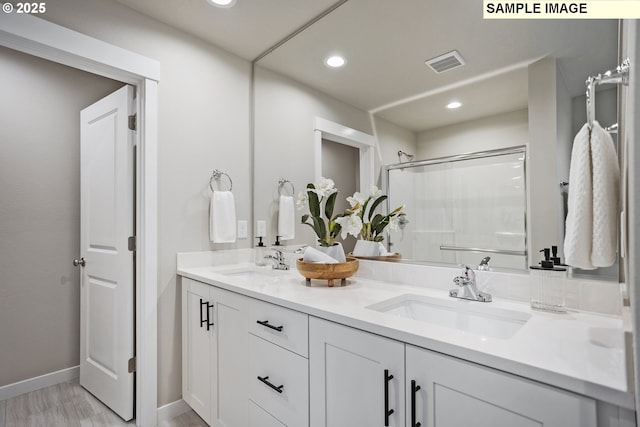 17407 SW Atfalati Ln Unit 45, Sherwood, OR 97140 - bathroom with recessed lighting, an enclosed shower, baseboards, double vanity, and wood finished floors