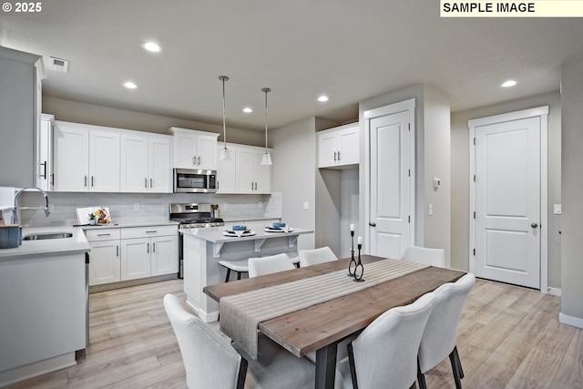 17407 SW Atfalati Ln Unit 45, Sherwood, OR 97140 - dining room with light wood-type flooring, recessed lighting, and baseboards