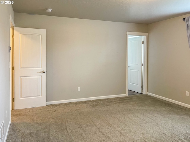 unfurnished room with carpet flooring