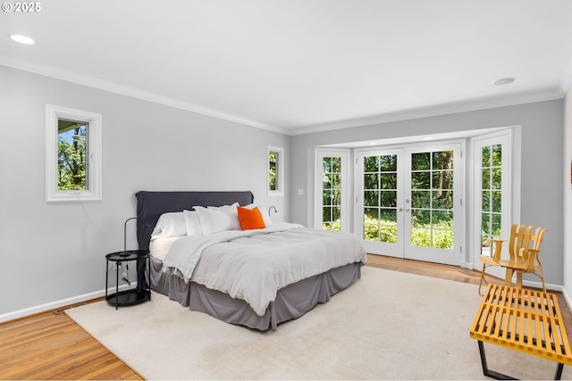 3925 SW Humphrey Blvd, Portland, OR 97221 - bedroom featuring wood finished floors, crown molding, multiple windows, access to exterior, and recessed lighting
