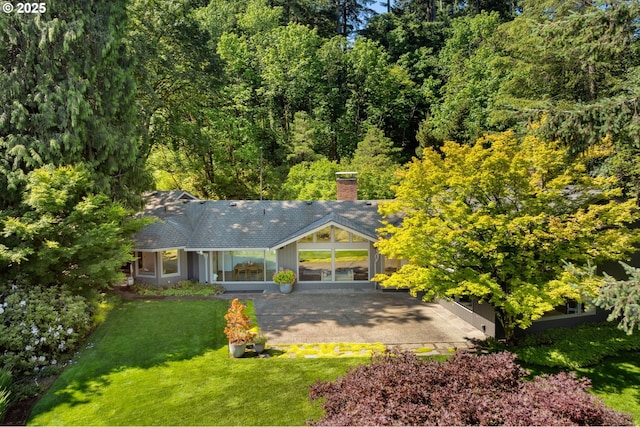 3925 SW Humphrey Blvd, Portland, OR 97221 - view of front of house with a front lawn and a chimney