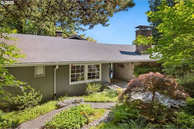 3925 SW Humphrey Blvd, Portland, OR 97221 - view of front of home featuring a chimney and roof with shingles
