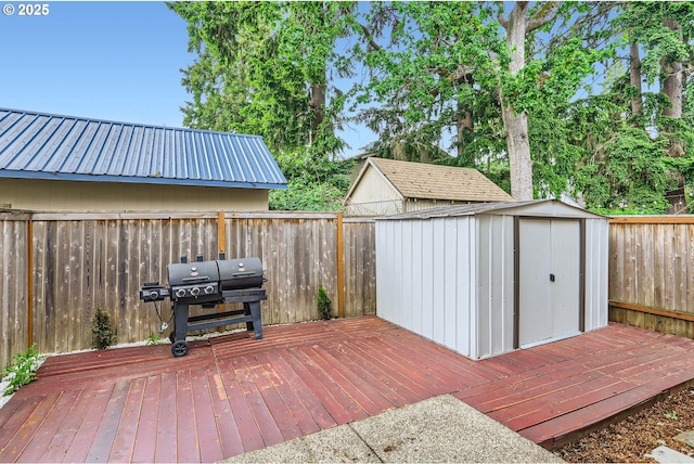 4451 SE Hardwood Ln, Hillsboro, OR 97123 - wooden terrace with a grill, a storage shed, an outdoor structure, and a fenced backyard