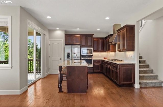 2964 NW Parkhurst Ter, Portland, OR 97229 - kitchen with stainless steel appliances, dark wood-style flooring, dark brown cabinets, a kitchen bar, and a sink