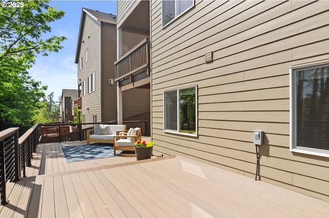 wooden terrace featuring outdoor lounge area