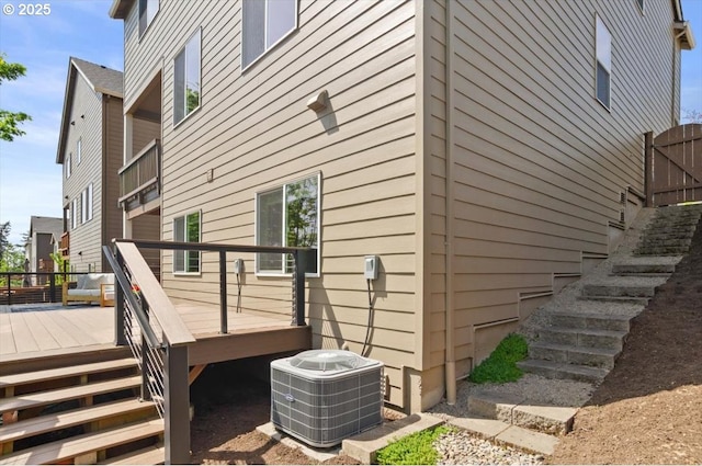 view of side of home featuring stairs, cooling unit, and a deck
