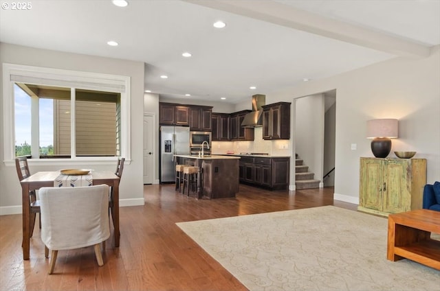 living area with recessed lighting, dark wood-style flooring, baseboards, and stairway