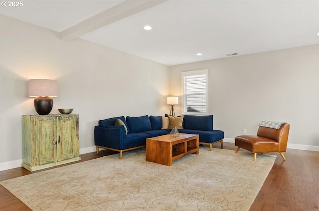living area with wood finished floors, baseboards, recessed lighting, and beam ceiling