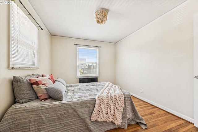 1411 N Alberta St Unit 1, Portland, OR 97035 - bedroom featuring wood finished floors and radiator